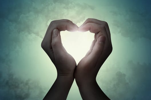 love shape hand silhouette in sky