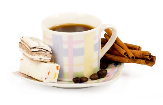 Coffee cup with sweets an cinnamon on white background