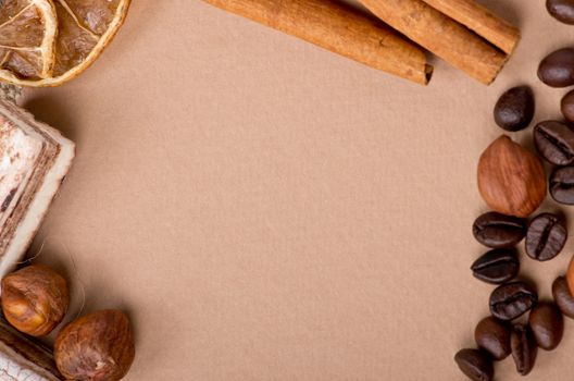 Close up of coffee, cinnamon, nuts, sweet on old paper material. Place for text.