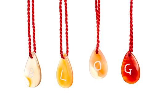 Blog word spelled with agates that are engraved with white letters and are hung by ropes, isolated against white background
