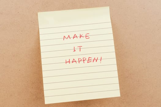 Make it happen words written on a sticky note