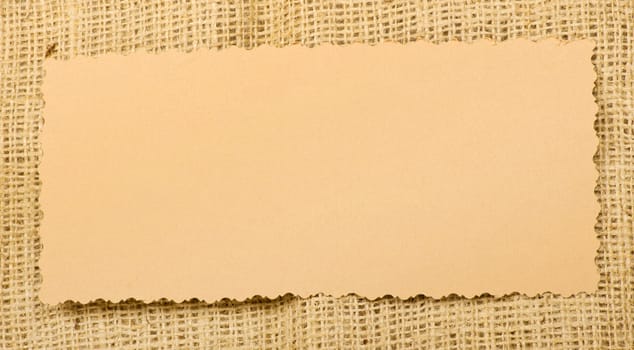 Old paper tag on natural burlap