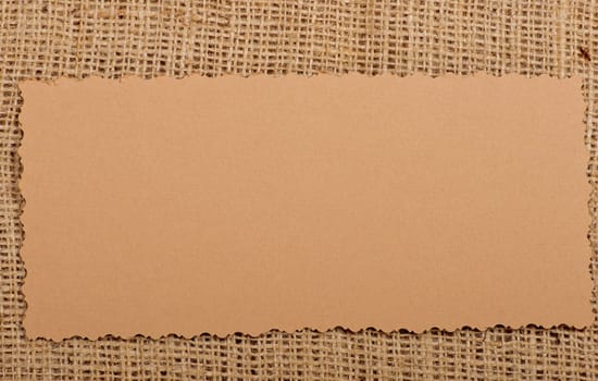 Old paper tag on natural burlap