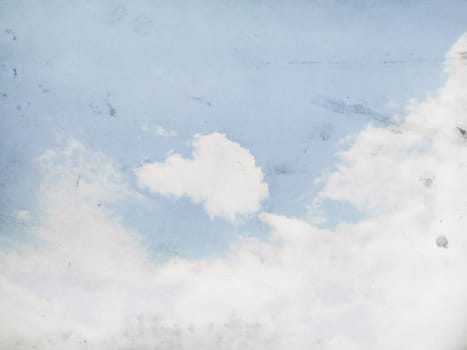 Fog and clouds on a vintage, textured paper background with a color gradient.