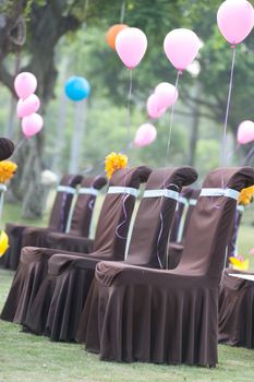 Chairs and balloons for wedding on the lawn