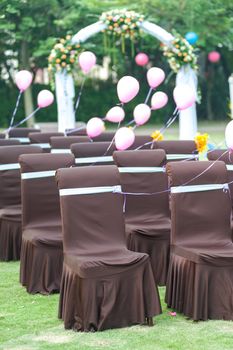 Group of chairs and balloons for wedding on the lawn