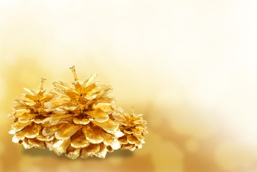 Golden pine cone isolated on white