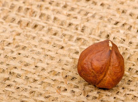 Hazelnuts on burlap background