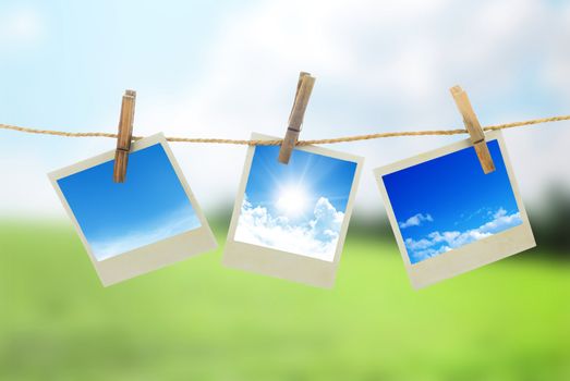 Three instant photos with sky inside hanging on the clothesline
