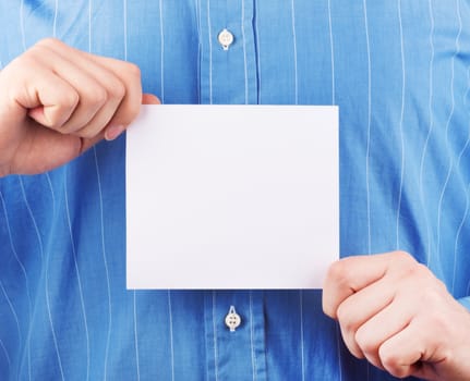 Closeup of businessman's hand holding up card