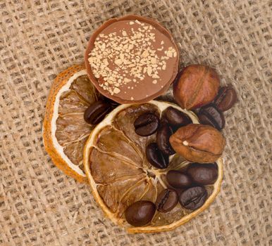 Sweet, lemon, nuts and coffee beans on burlap