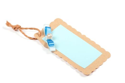Blank tag tied with brown string. Price tag, gift tag, sale tag, address label, etc.