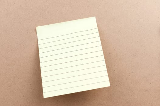 Blank sticky note attached on the wooden board