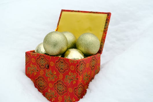 christmas tree toys in retro colorful box on winter snowbank snow.