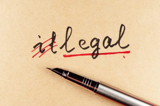 amending Illegal word and changing it  to legal using a pen