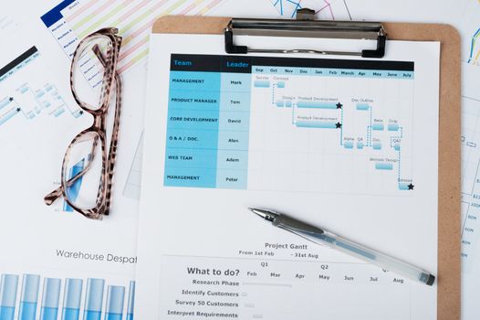 Gantt diagram printed on white paper with a pen on it