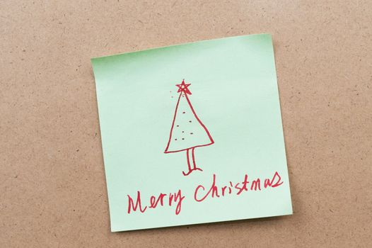 Merry Christmas words written on a sticky note