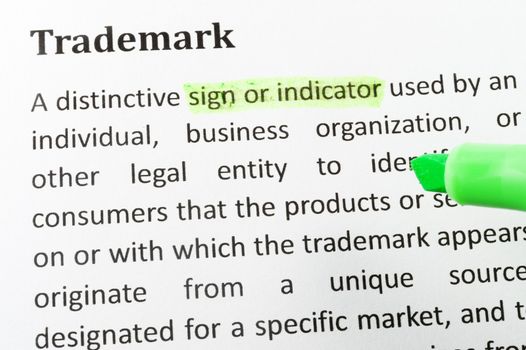 Highlighter and trademark concept words on paper