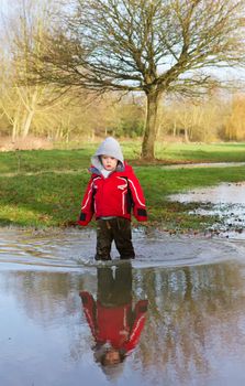 boy standing in flood waters