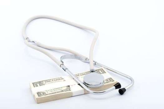 Stethoscope on a pile of paper money