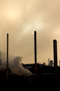 silhouette of an industrial premises with steam billowing out