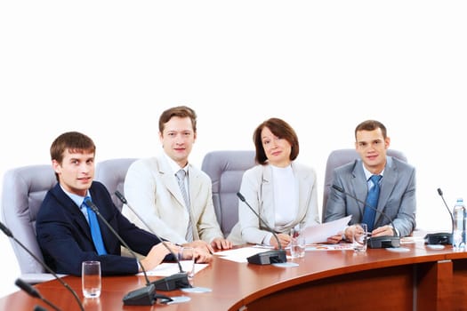 Image of four businesspeople discussing at meeting