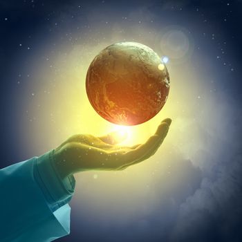 Hand of businessman holding earth planet against illustration background