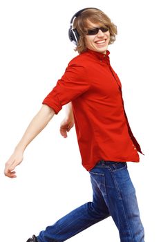 Happy smiling young man dancing and listening to music