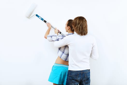 Portrait of young couple with paint brushes