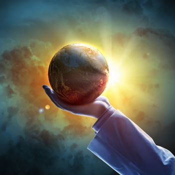 Hand of businessman holding earth planet against illustration background