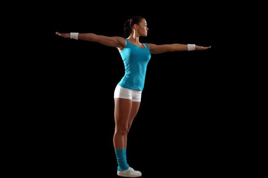 Fitness woman smiling standing against black background