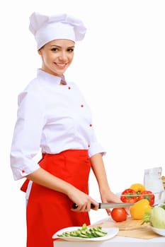 Young cook preparing food wearing red apron