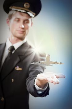 Image of pilot with airplane taking off from his hand