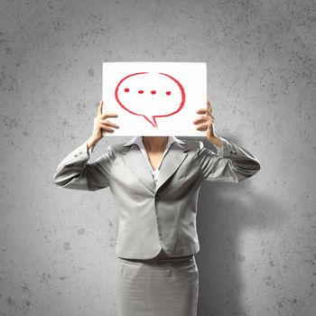 Image of businesswoman holding message board against face. Conceptual photo