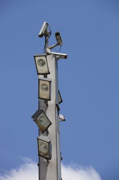 Surveillance cameras and floodlights on top of the pole