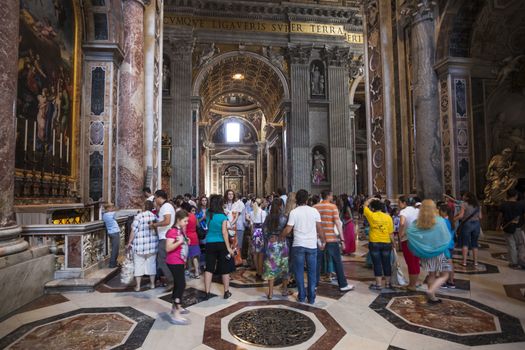 ROME - June 22: Crowd of tourists Indoor St. Peter's Basilica on June 22, 2012 in Rome, Italy. St. Peter's Basilica is a Late Renaissance church one of largest Christian church in world