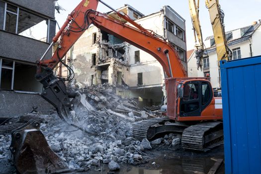 Demolition of an old building with heavy machinery for new construction