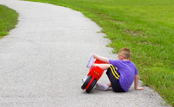 little boy fallen off of his bike