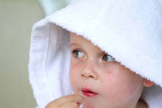 little boy wearing a white bath robe