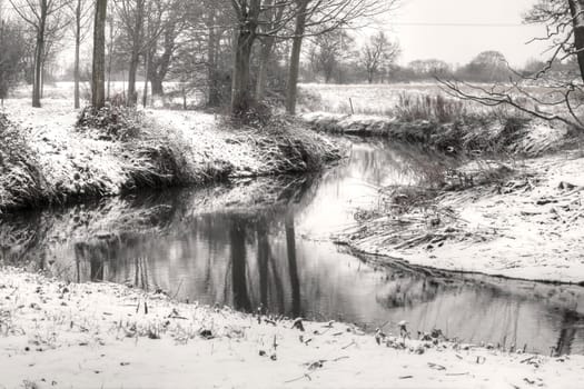 snow scene with river running through