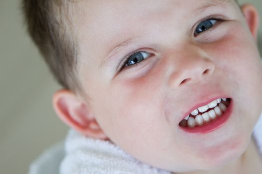 little boy smiling wearing his bath robe