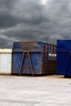 recycling centre waste bin with a cloudy grey sky