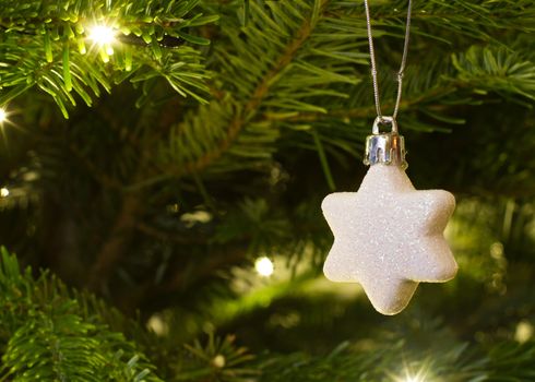 christmas star hanging on the christmas tree