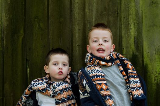 brothers outside by a old wooden hut