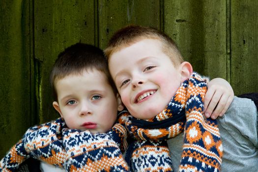 brothers outside by a old wooden hut