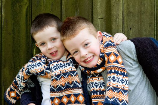 brothers outside by a old wooden hut