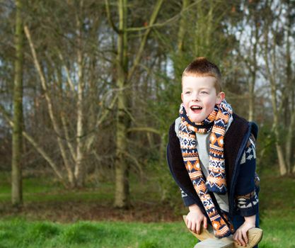 little boy jumping with joy outdoors in countryside