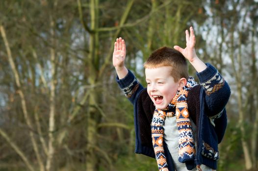 little boy jumping with joy outdoors in countryside