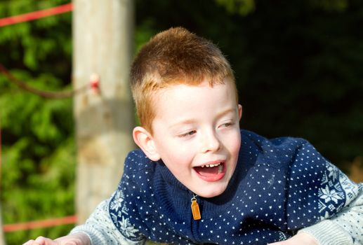 Young boy playing outside in cold weather