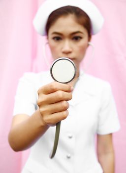 Young nurse with stethoscope cheking